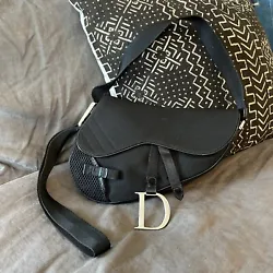 Super cute vintage Dior sport saddle bag from 2002. Body of the bag is a black nylon or canvas and it has mesh details...