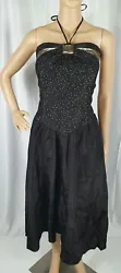 Beautiful 80s prom dress in black with shiny gold detailing in bodice. Bodice is a black lace overlay with gold polka...