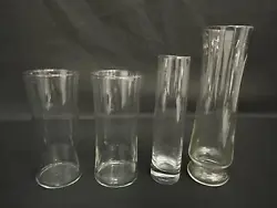 This is a lot of 4 clear cylinder vases. These vases are in good pre-owned condition.