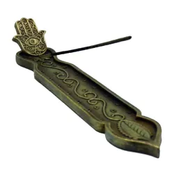 A boat style incense holder and ash catcher with elegant engravings including a large leaf at one end connected by...