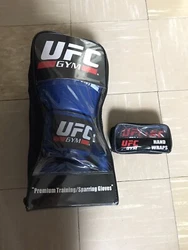 UFC GYM GLOVE 14OZ with CLOTH WRAPS BLACK - Never Used. Shipped with USPS Priority Mail.The gloves and wraps are still...
