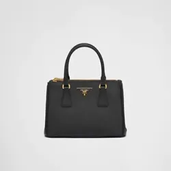 The bag is decorated with the lettering logo on a leather triangle. From the Prada website Product code:...
