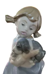 Beautiful Nao by Lladro figurine of a young girl holding her sleeping puppy dog. Approximately 7.5” tall. Great...