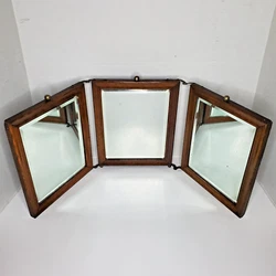 Up for sale is this antique folding mirror. It is very heavy for its size.