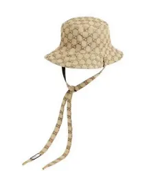 This Gucci hat is a must-have accessory for any fashion-forward individual. The GG canvas and nylon beige bucket hat is...