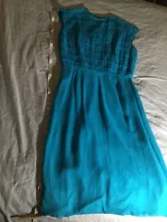 Beautiful vibrant teal or almost neon blue L’aiglon party dress made 63-64! Sleeveless and midi skirt.
