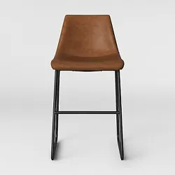 •Elegant and sophisticated counter stool alludes to the Mid Century décor •Upholstered in faux leather with an...
