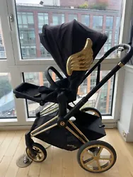 This is a COLLAB between cybex and designer Jeremy Scott. Stroller w gold wings and accents. Lux carry cot for infant....