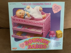 Deluxe changing table an play accessoriesIncludes lift out changing pad,2 slide out drawers,Roll poly toy and play...