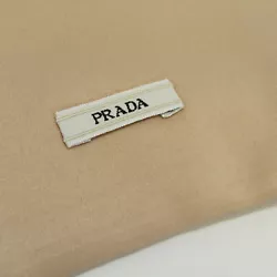 Elegant blush pink color! Satin dust bag by PRADA. Has beige woven drawstring closure. Logo label near bottom of bag.