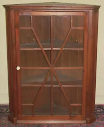 This cabinet is defined by a 12 light fret worked door with original glass, glazing and finish. It has a superbly...