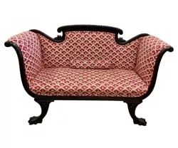 Stunning antique carved mahogany settee with scroll arms and carved claw feet.