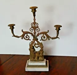 This three branch candelabra is from the 1850s, the Civil War Era. It is attached to a marble base that has no...