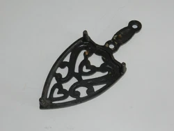 ANTIQUE SAD IRON TRIVET. WITH SCROLL AND HEARTS. AND IN NICE CONDITION AS SHOWN.