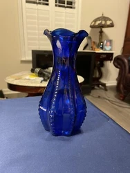 Made by Indiana Glass in the 1940s, this piece features a beautiful cobalt blue color and a ribbed scalloped rim...