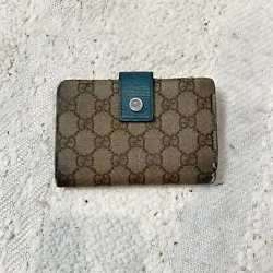 Gucci brown monogram and blue leather wallet with card slots, cash section and kiss lock coin section. Shows wear....
