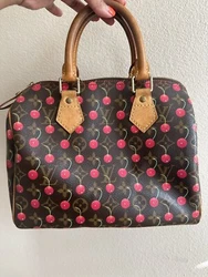 Such a fun and stunning bag. This is the highly sought after Louis Vuitton Speedy 25 Cerise. It has the regular...