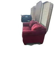 comfortable red velvet sofa in good condition.