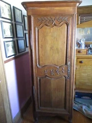 Antique 18th Century French clothing cabinet. It has a single door that opens to the left. The door is hand carved with...