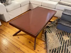 This is a rare mid-century modern Castro Convertibles table from the 1950s. The coffee table converts to a dining table...