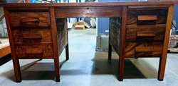 This antique double pedestal mahogany desk from Doten Dunton is a stunning piece of furniture that will bring character...