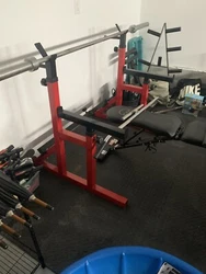 weight lifting gym equipment. Squat rack, adjustable bench, and land mine attachment