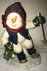 A Skiing Snowman! Hes wearing Mittens, a Knit Hat & Vest and his Scarf is blowing in the wind behind him! Hes leaning...