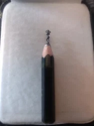 Woman posing carved pencil. A number 2 regular pencil lead is carved to shape of a woman posing