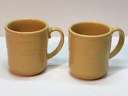 This is a great set of 2 Longaberger Pottery coffee mugs in their iconic Woven Traditions pattern. The color is called...