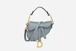 The iconic Saddle bag is updated by Maria Grazia Chiuri in a micro format. Crafted in cloud blue goat leather, its...