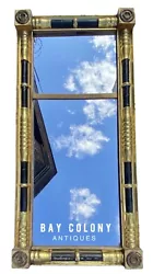This mirror possesses a superior high luster gilt surface with convex panels behind the columns to throw more light...