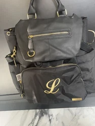 Diaper bag backpack - used ONE time - still has tag on it. Great condition - excellent outside condition . Gold letter...