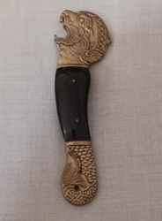 This antique bottle opener from Thailand features a unique design of a lion head and serpent fish tail made of wood and...