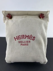 HERMES sand colored arine canvas sellier bag with red details. The cutest little canvas bag with red leather drawstring...
