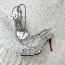Christian Louboutin clear and silver metallic leather peep toe T-Strap stiletto heels with buckle closure. Good used...