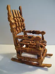 This piece was made using wooden clothes pins. These were then stained a honey brown color with wood-burned accents....