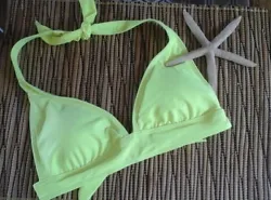 The color is a bright neon yellow. Ties around the back of the neck as well as the mid back. Its really cute!