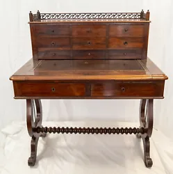 This late 19th Century desk has great traditional victorian English style with Lyre legs and decorative gallery on the...