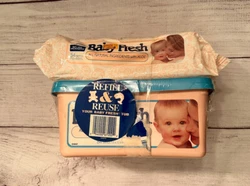This vintage 1992 movie prop features an unopened box of Pampers Baby Fresh baby wipes, along with a refill pack. The...