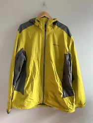 This is an Eddie Bauer First Ascent rain jacket, size Mens TXL. It is yellow and gray. The jacket has an adjustable...