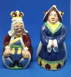 The King and Queen of Hearts. The King sits on his heart throne while the queen stands clad in her dark blue robes and...