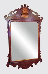 The mirror has an incised gold gilt liner and beveled cut glass. This is one of two similar of these Freidman mirrors...