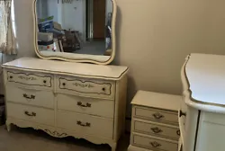 This beautiful set of furniture includes a dresser with mirror, a chest of drawers, and a small end table with drawers.