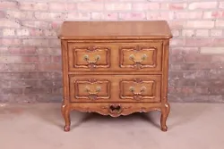 By Auffray & Co. A gorgeous French Provincial Louis XV style commode or chest of drawers. Carved walnut, with original...