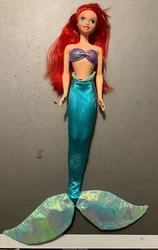 Includes Ariel doll, bikini top & bottom, green tail, & tropical tail.