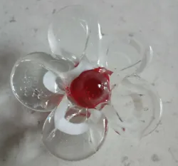 Unique, handmade paperweight. Flower head has clear petals with white swirl and red center. Bubble design on petals...