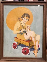 Cette pièce est une ravissante pin up art déco, une femme assise sous un parapluie dans un wagon jouet, avec le titre...