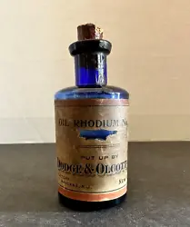 DODGE & OLCOTT CO. OIL RHODIUM No. 2. Beautiful cobalt blue color with original labels and original cork. Bottle is in...