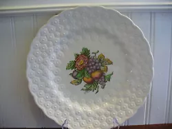 This plate is pretty. It is made of porcelain and has a creamy white high gloss finish. It is round in style with an...