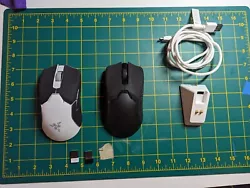 Two Used Razer Viper Ultimate mice with a white charging dock and cable.  Both have 3rd party skates and mice grip...